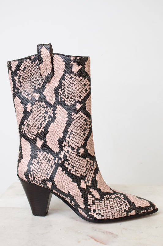 A mid-calf western-style boot with a pink and black snakeskin pattern, featuring a dark brown block heel and pointed toe, set against a plain white background.