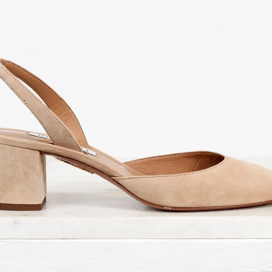 Beige suede slingback shoe on a white background