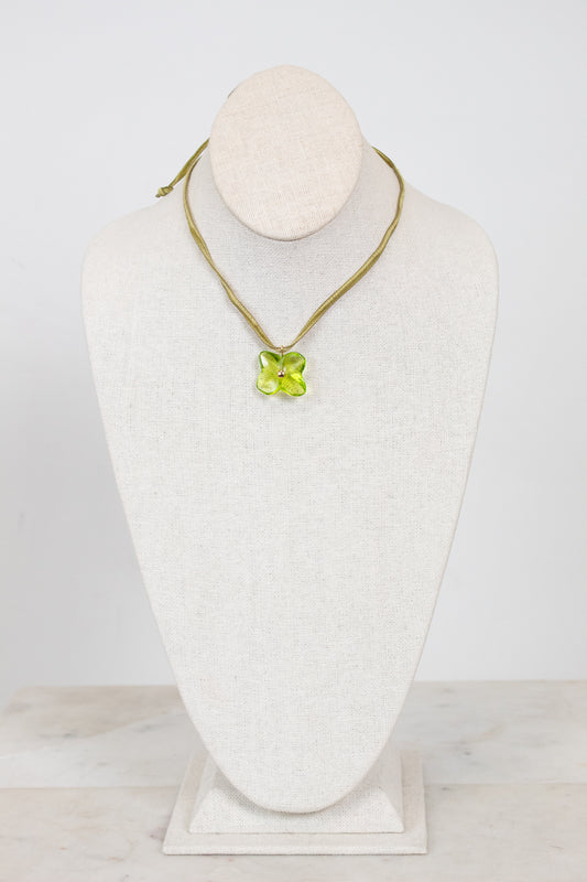 Choker necklace with a green pendant on a mannequin bust against a white background