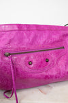 Purple handbag with a textured surface on a light background