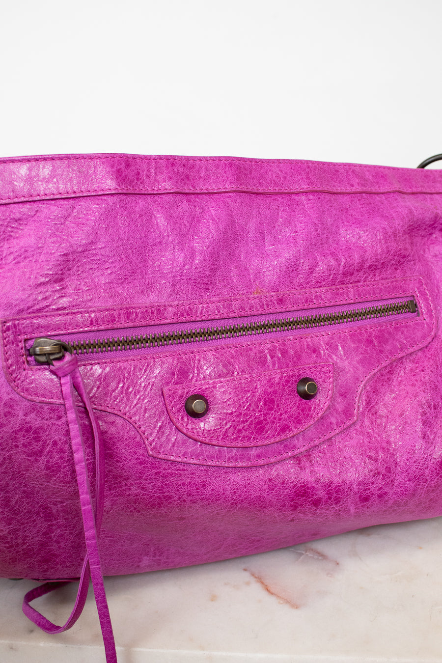 Purple handbag with a textured surface on a light background