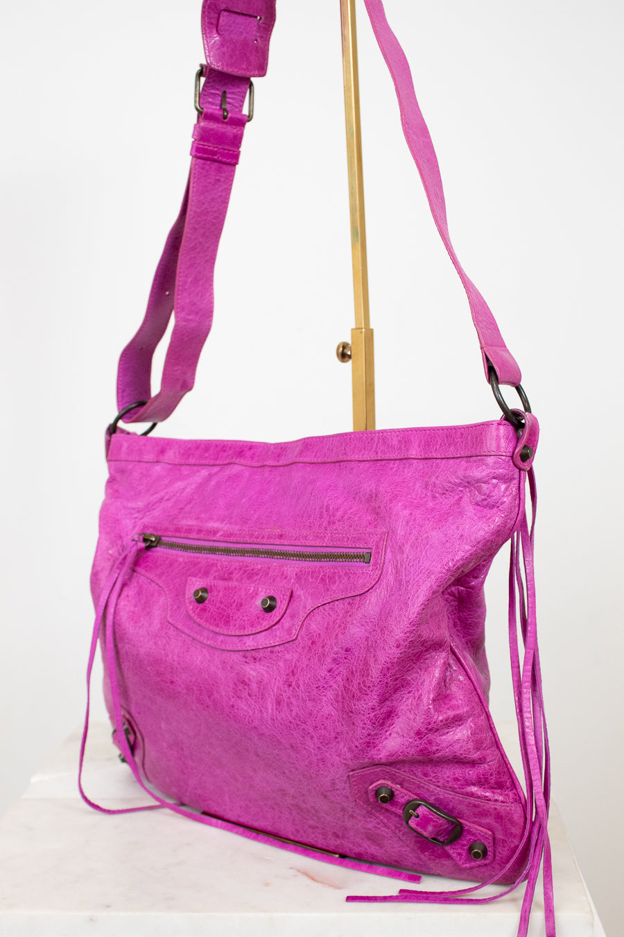 Pink shoulder bag with a strap on a white background