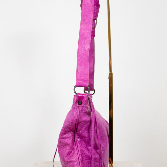 Pink backpack with a strap on a white background