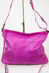 Purple handbag with a strap on a white background