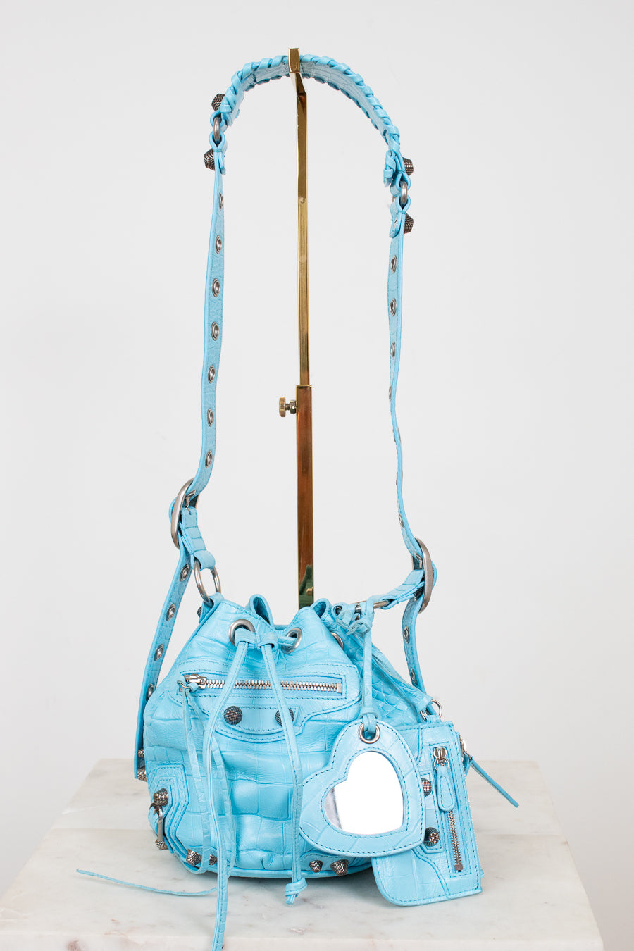 Light blue handbag with decorative elements on a white background