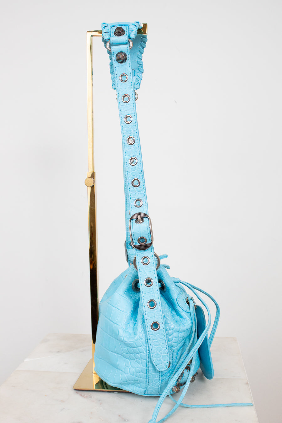 Light blue handbag with a strap on a white background