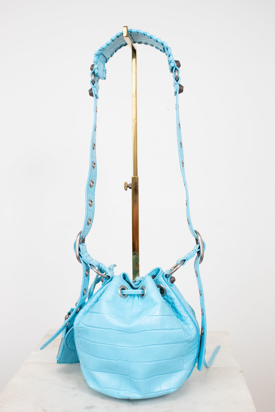 Light blue bucket bag with a strap on a white background