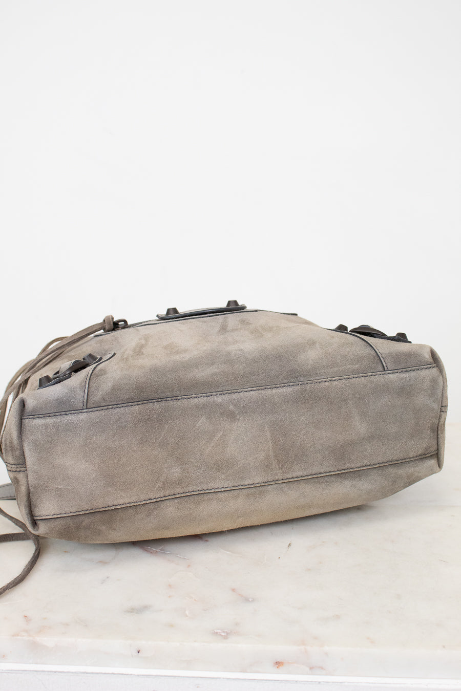 Gray shoulder bag on a white marble surface