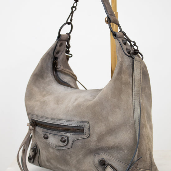 Gray shoulder bag with a strap on a white background