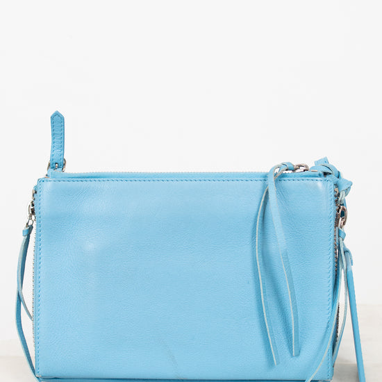 Light blue handbag with a strap on a white background