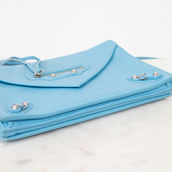 Light blue clutch bag on a marble surface