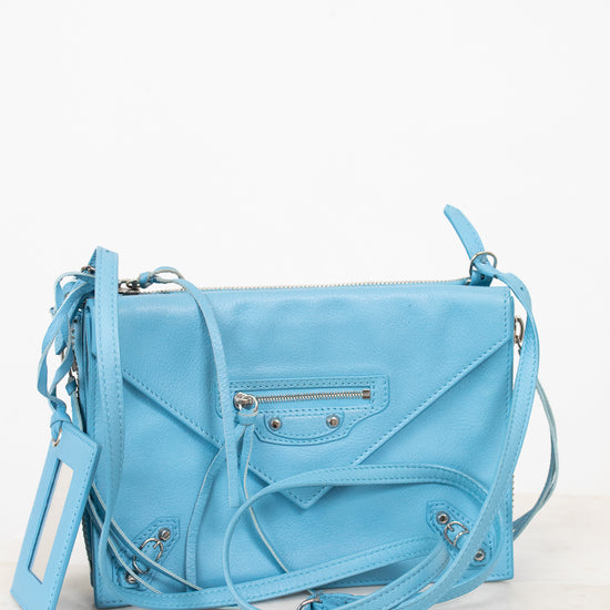 Light blue handbag on a white background