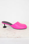 Pink high-heeled slip on heel sitting on a light marble background