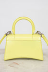 Yellow handbag with a marble background