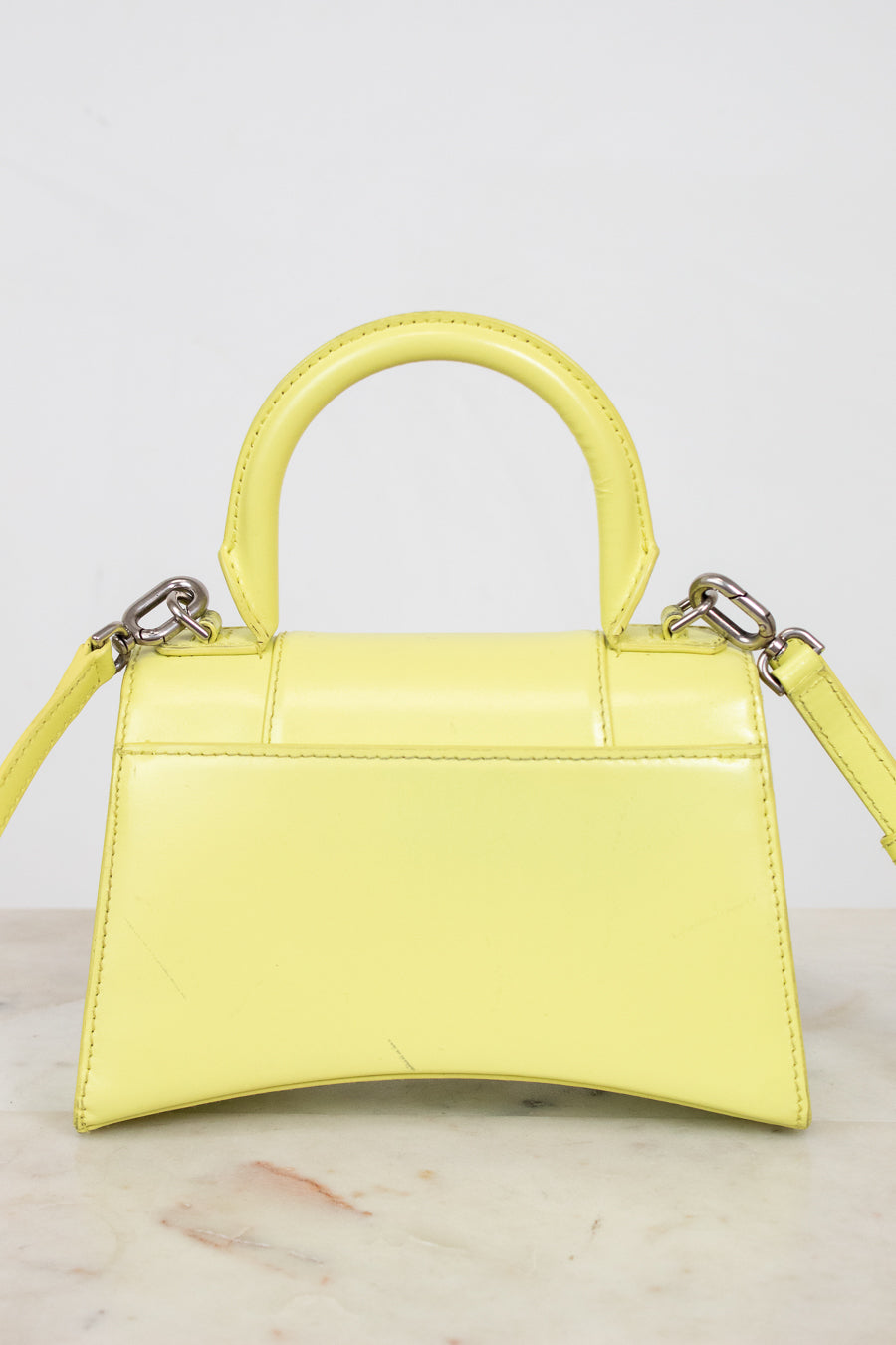 Yellow handbag with a marble background