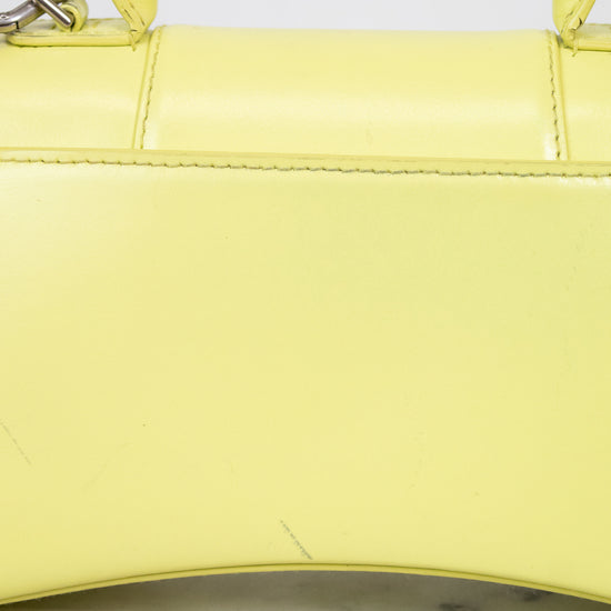 Close-up of a yellow handbag on a marble surface