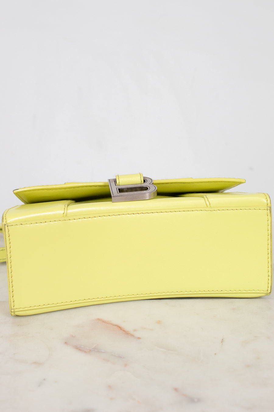 Yellow clutch bag on a light gray background