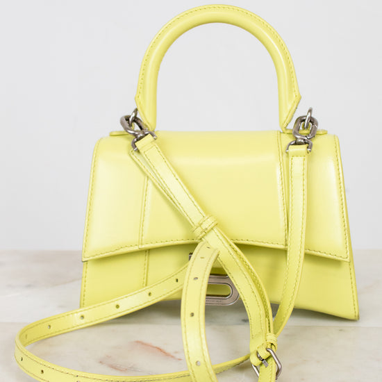 Yellow handbag with a strap on a light background