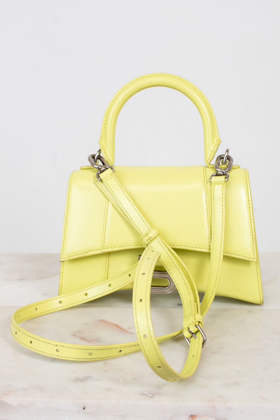 Yellow handbag with a strap on a light background