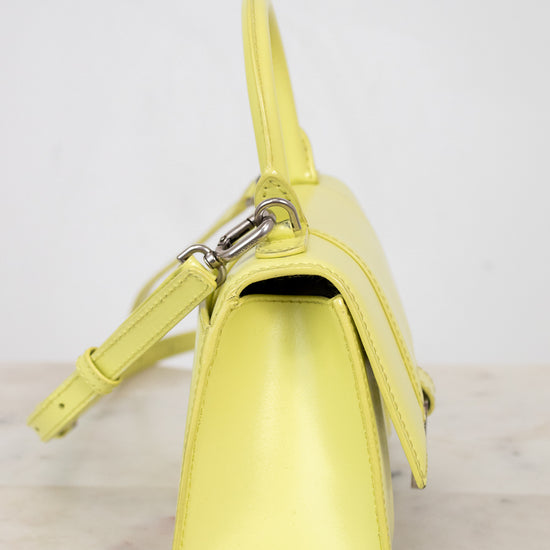Yellow handbag on a light gray background