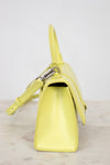 Yellow handbag on a light gray background