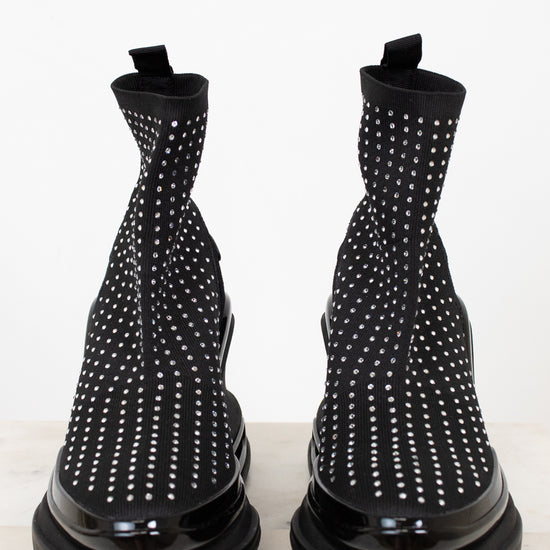 Black boots with silver studs on a white background
