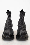 Black boots with silver studs on a white background