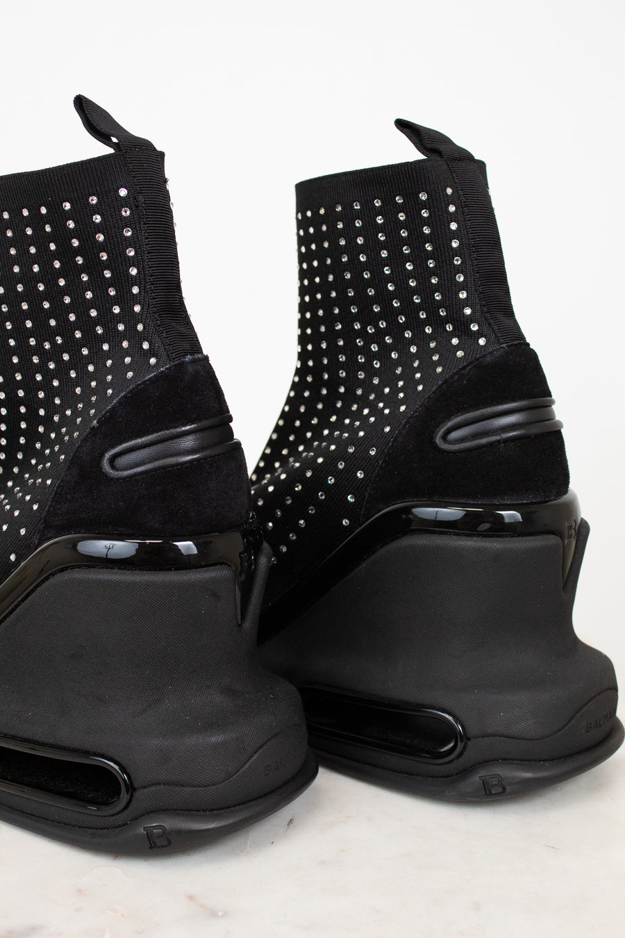 Black studded ankle boots on a white background