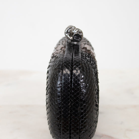 Black textured clutch bag on a white background