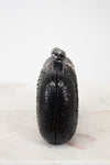 Black textured clutch bag on a white background