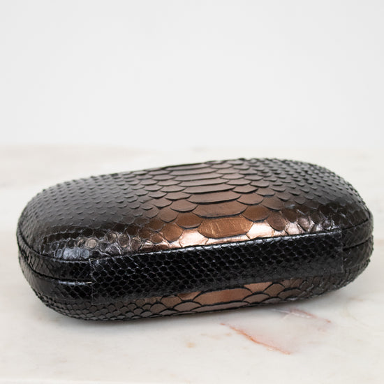Black textured clutch on a white surface