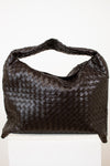 Brown woven oversized handbag on a white background