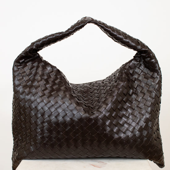 Brown woven oversized handbag on a white background
