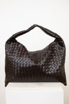 Brown woven oversized handbag on a white background