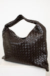Brown woven oversized handbag on a white background