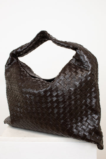 Brown woven oversized handbag on a white background