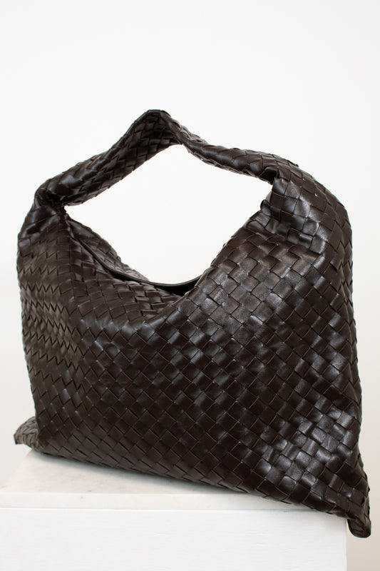 Brown woven oversized handbag on a white background