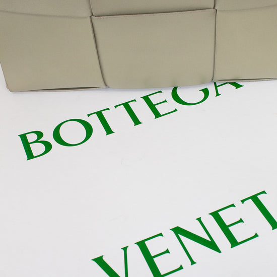 Close-up of a Bottega Veneta product with green text on a white background