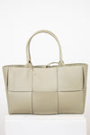 Light green woven handbag on a white background