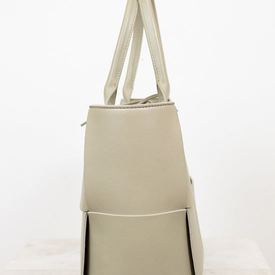 Light green woven handbag on a white background