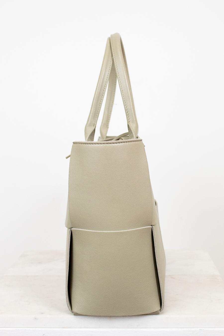 Light green woven handbag on a white background