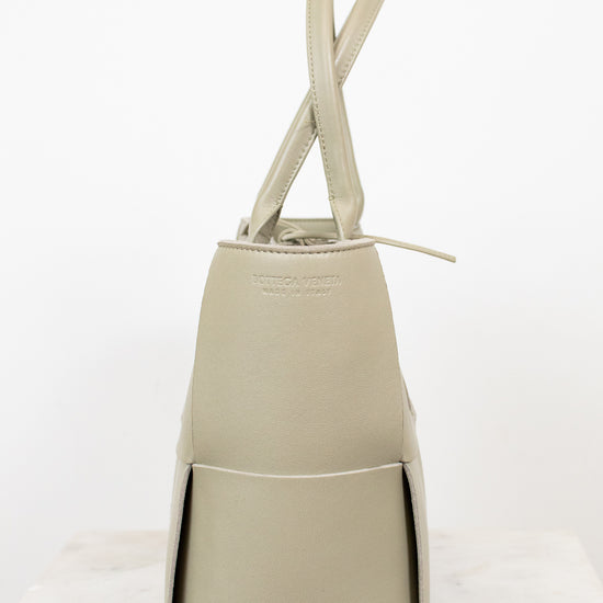 Light green woven handbag on a white background