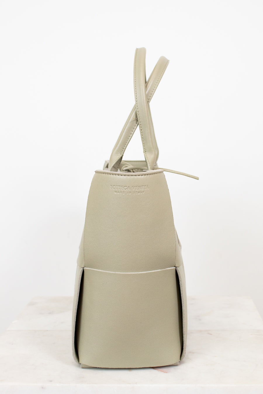 Light green woven handbag on a white background