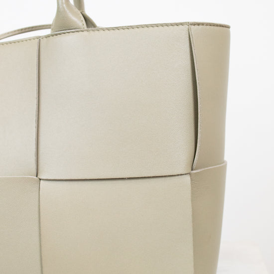 Light green woven handbag on a white background