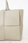 Light green woven handbag on a white background