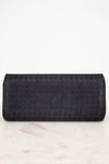 Black woven clutch bag on a marble surface