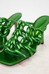 Green metallic sandals with braided design on a light background