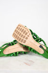 Green sandal with wooden insole on a white background