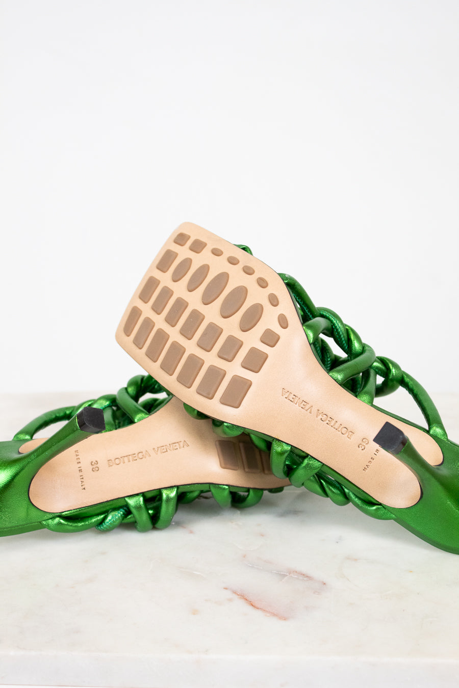 Green sandal with wooden insole on a white background