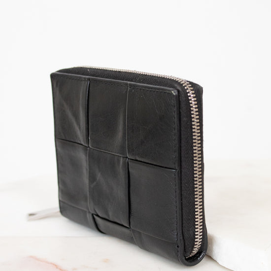 Black leather wallet with zipper on a white background